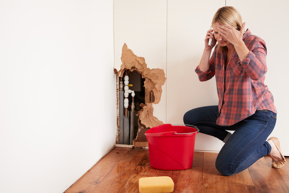 Woman stressed about water damage in her home