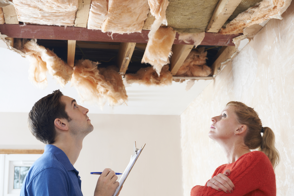 Ceiling insulation and tile peeled back after home damage