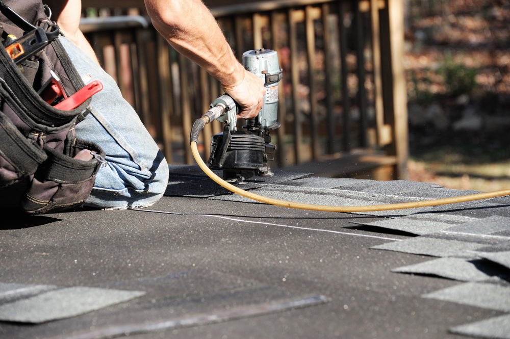 Restoration Technician Restoring Roof Shingles