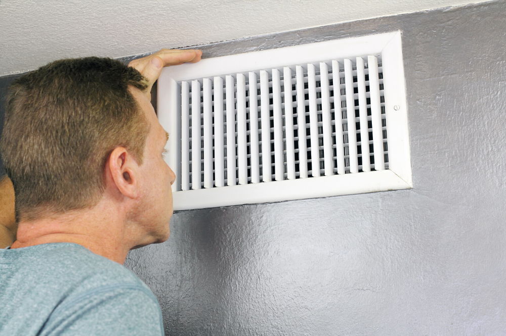 man looking at his home air duct